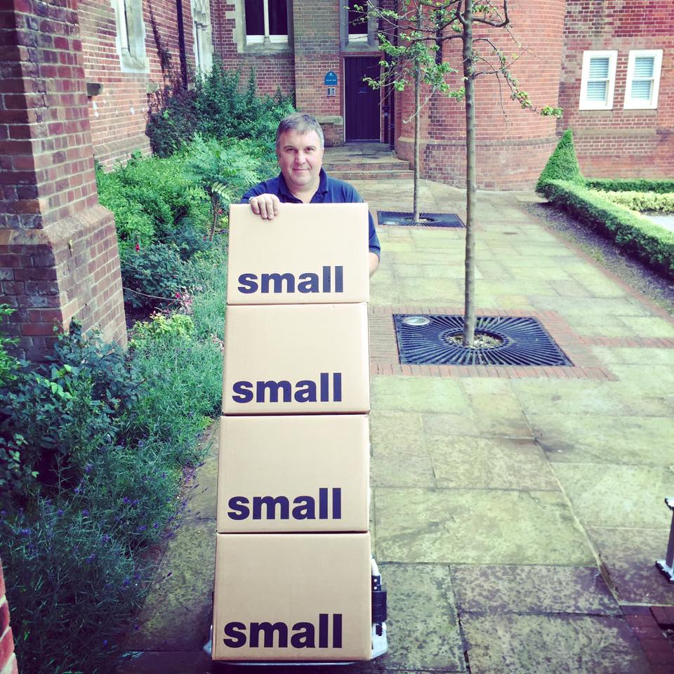 Removals Brighton team member with stacked moving boxes