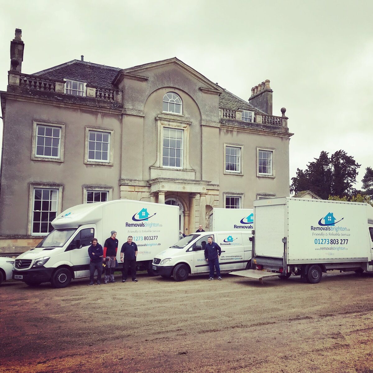 Full Removals Brighton fleet and team outside a grand Sussex manor house