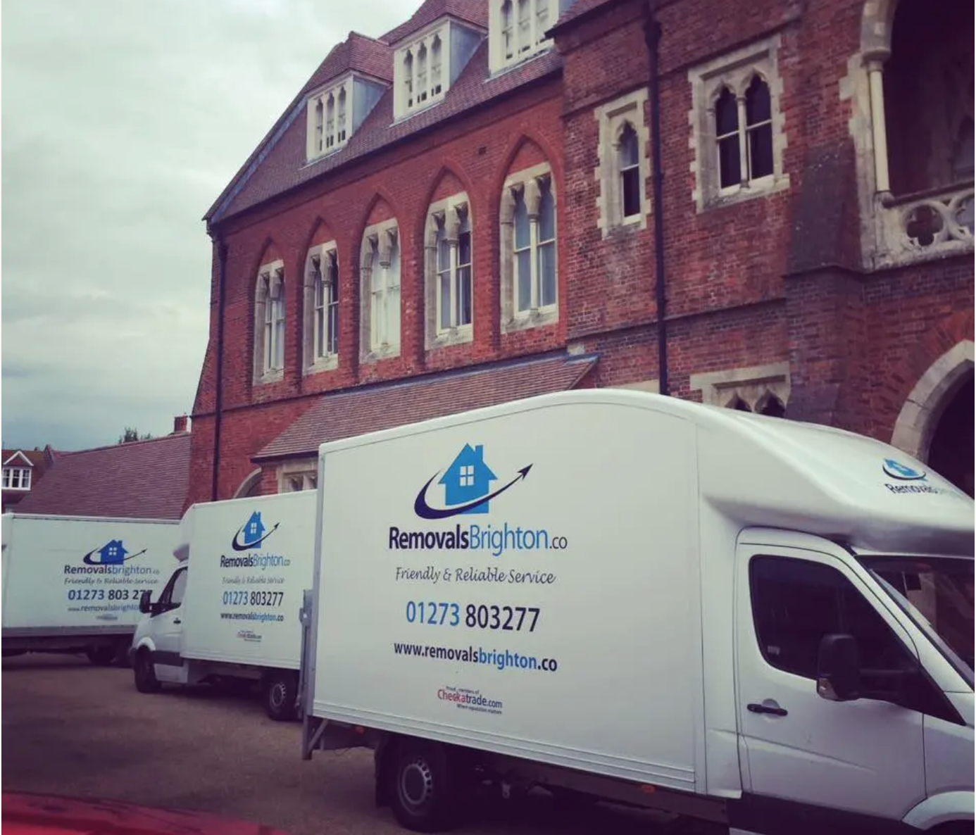 Three Removals Brighton vans at an office relocation