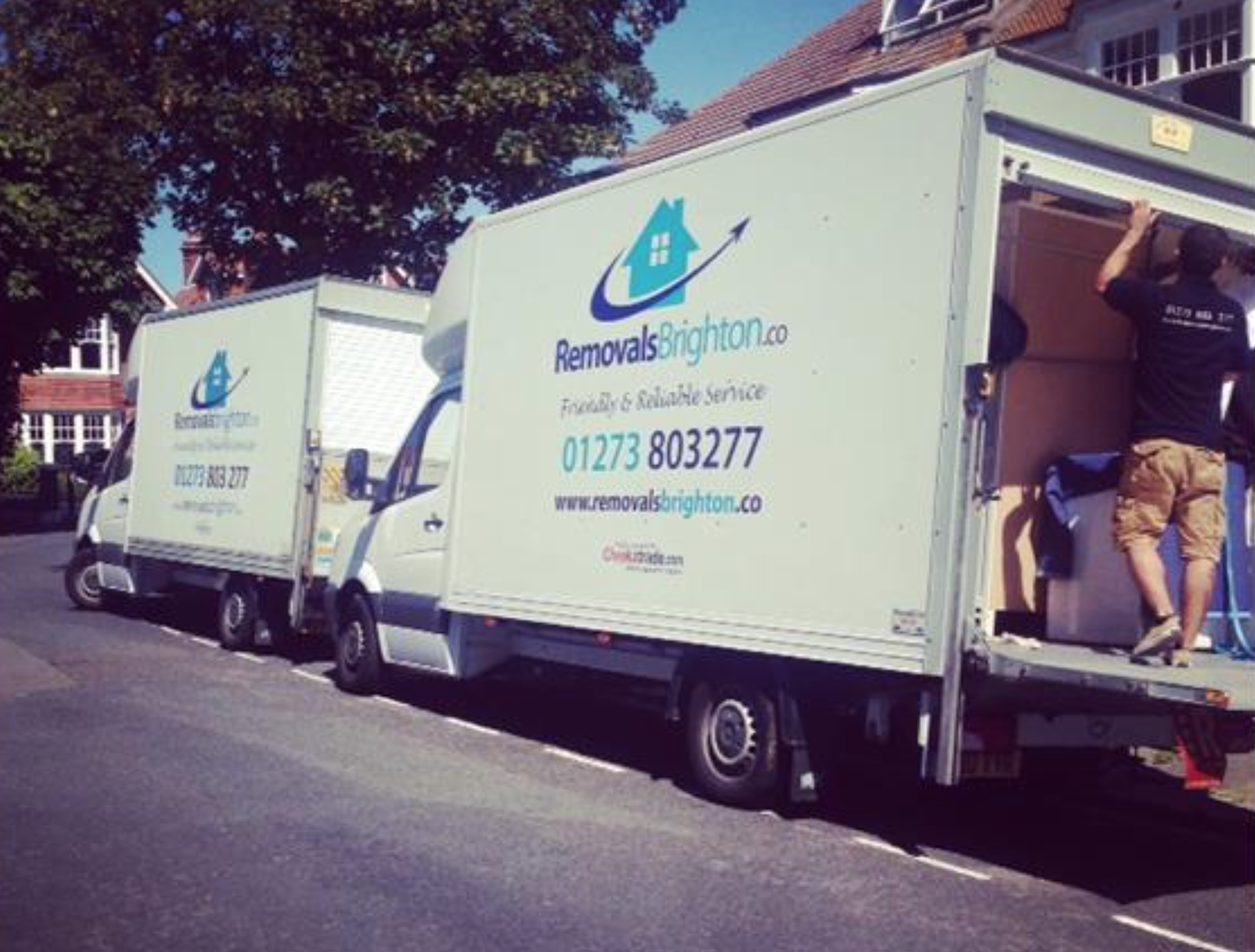 Two Removals Brighton vans with team loading on a Brighton street