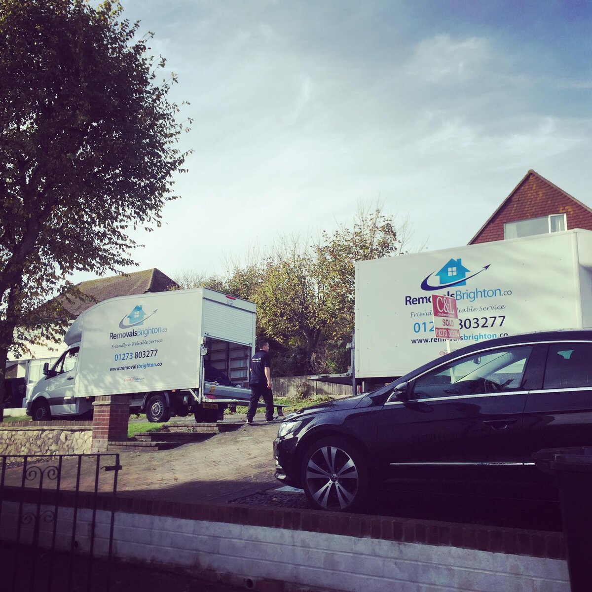 Two Removals Brighton vans at a sold residential property in Sussex